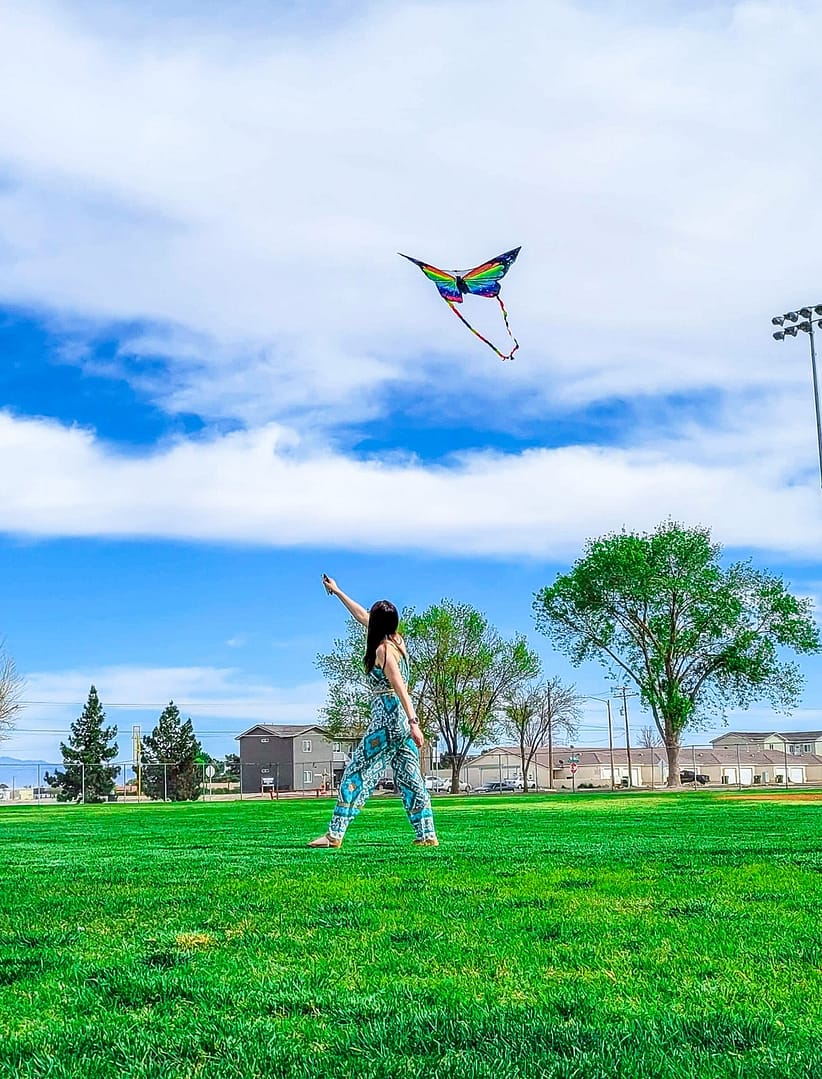 woman flying butterfly kite